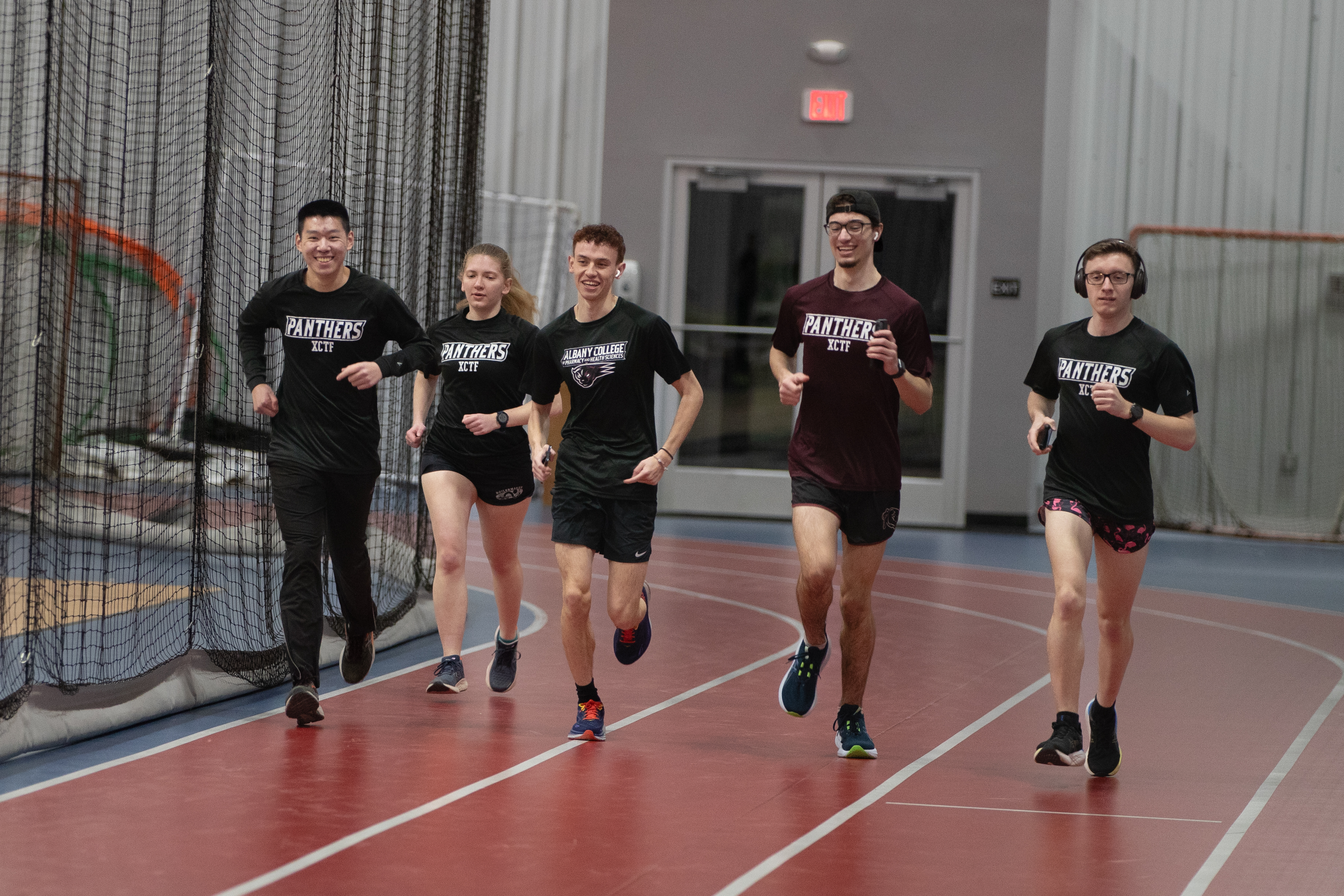 Track and Field team members running on the track at Albany Academy