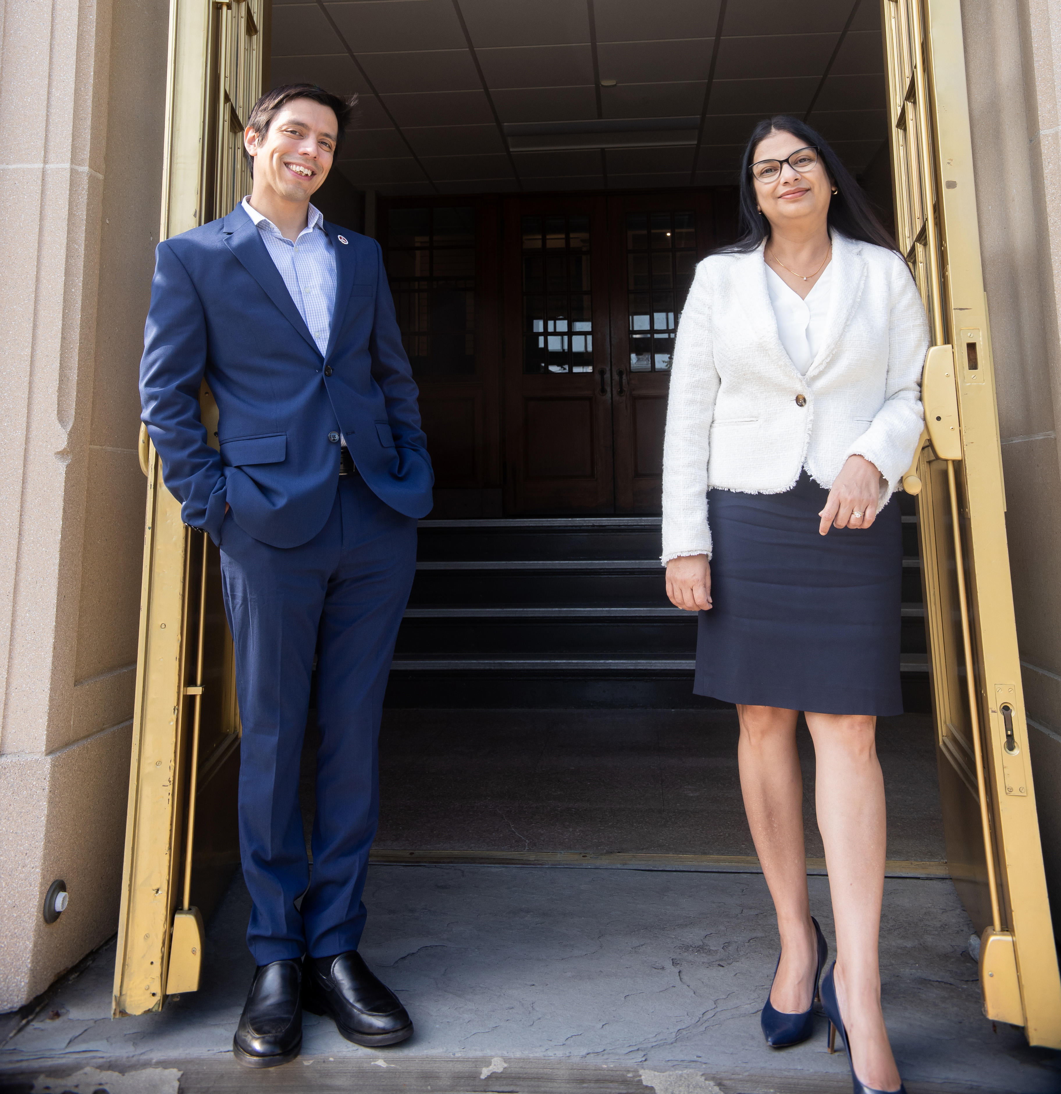 Dr. Jo Carreno and Dr. Meenakshi Malik stand outside of the O'Brien building on campus. 