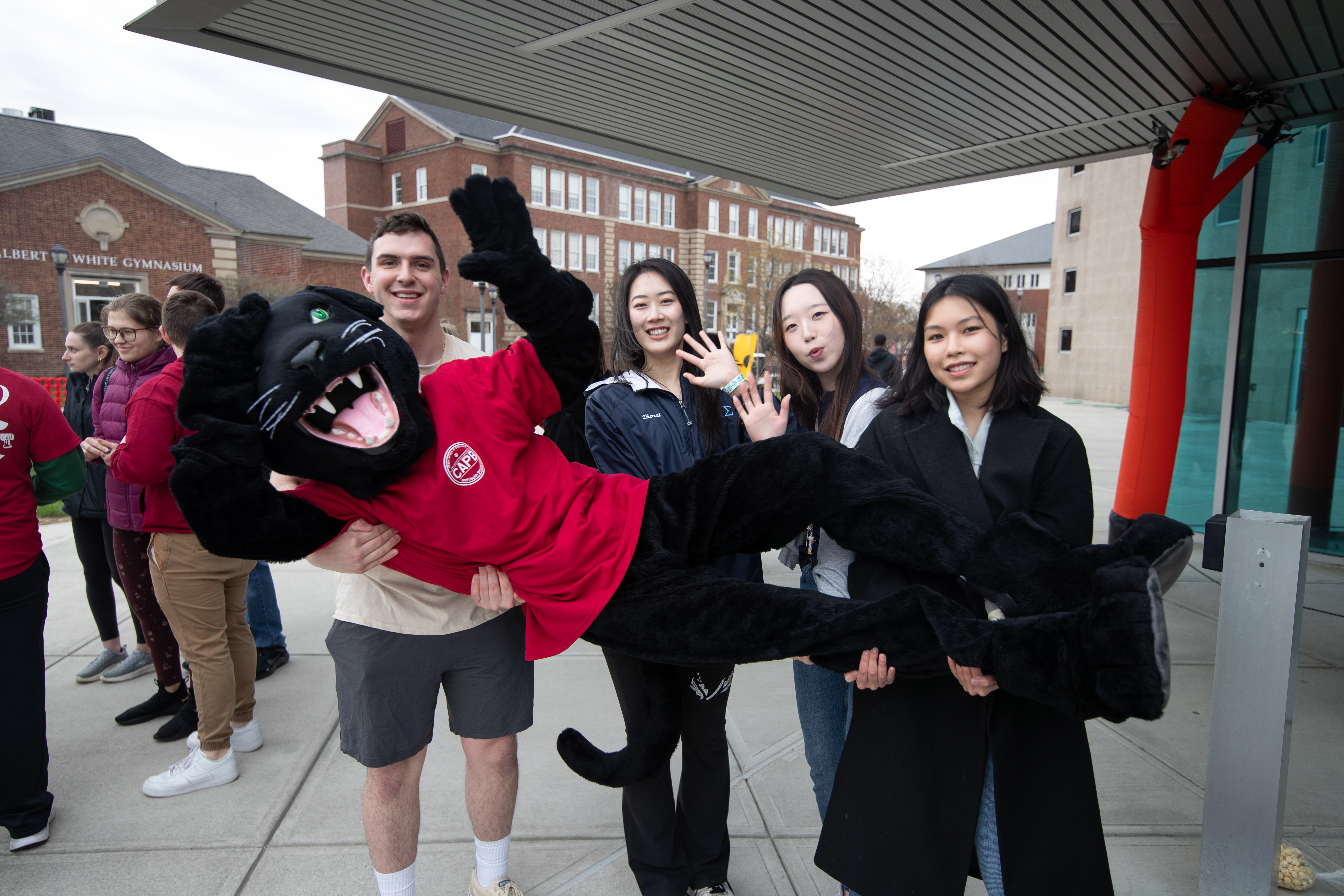 Students hold Paws the mascot at Springfest 2024