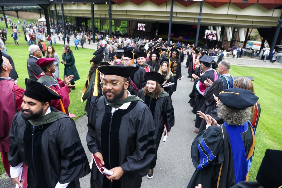 Graduates walk out of commencement ceremony