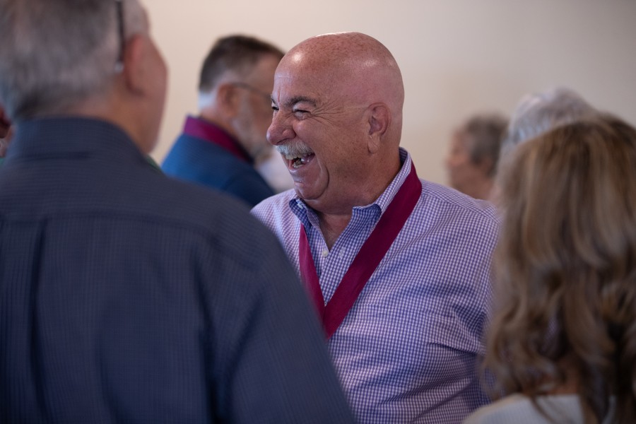 Alumni laugh together at event