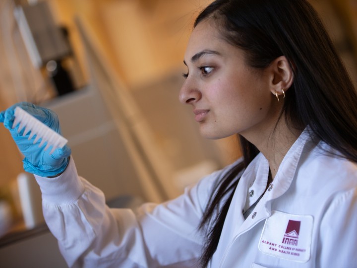 A student examines a lab sample