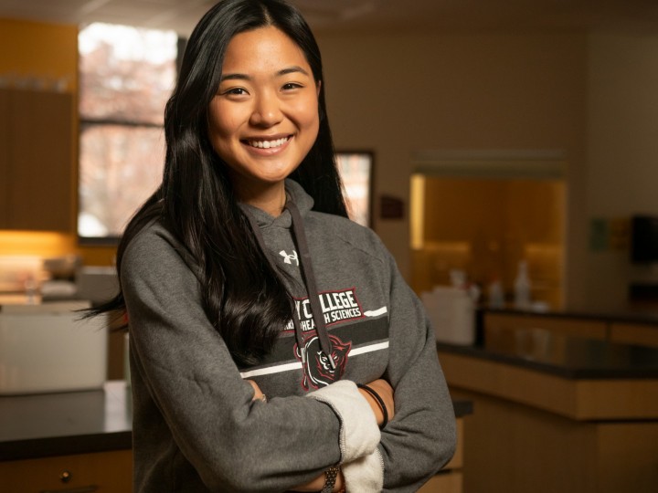 Soo K. stands in lab with arms crossed